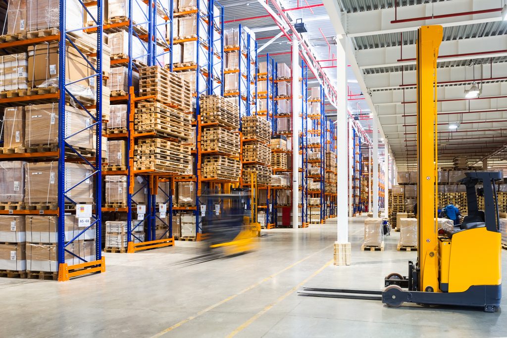 fulfillment trend 2024 Large modern warehouse with forklifts